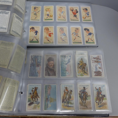 752 - Two albums of John Player cigarette cards; old footballers, old caricatures, etc.