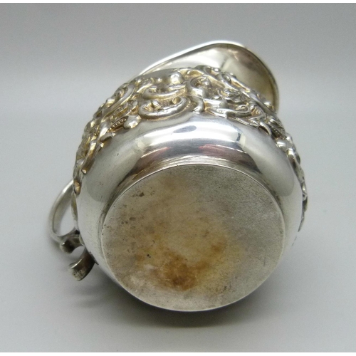 811 - A silver embossed jug, Birmingham 1902, 73g