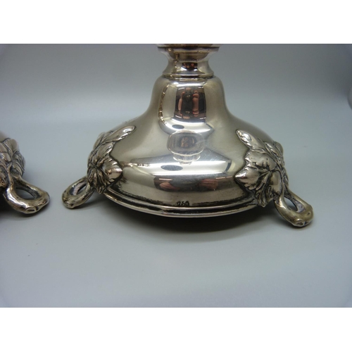 815 - A pair of continental silver candlesticks, marked 750, 270g