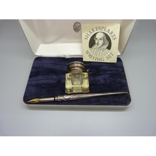 824 - A Shakespeare silver writing set, hinge on ink bottle stressed