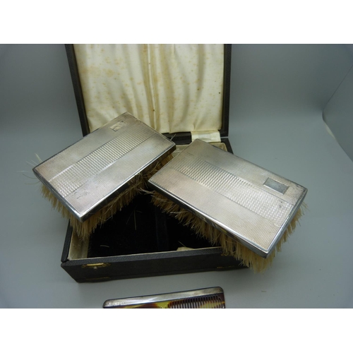 830 - A pair of silver backed brushes and comb set, cased