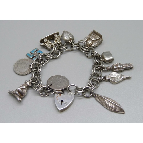 876 - A white metal charm bracelet, 41g