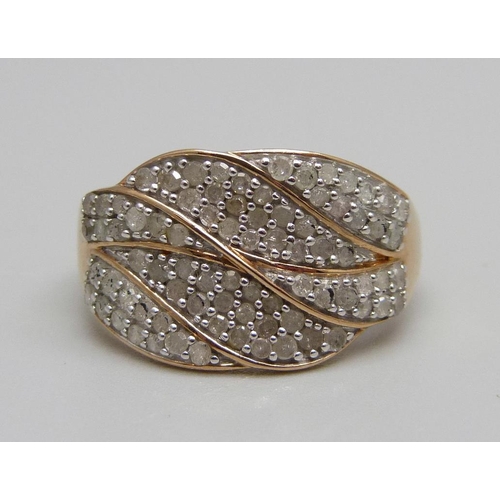 883 - A 9ct gold ring pave set with approximately eighty diamonds, 3.8g, S