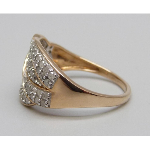 883 - A 9ct gold ring pave set with approximately eighty diamonds, 3.8g, S