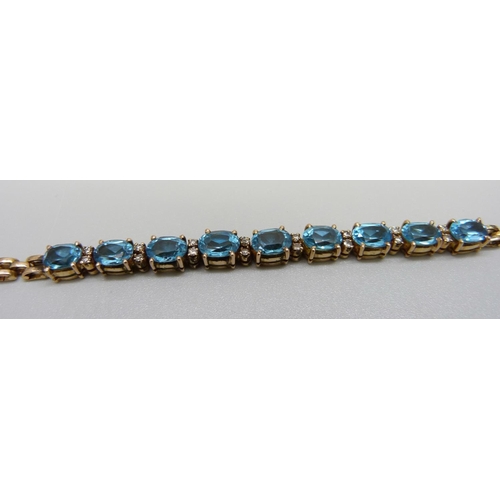 926 - An 18ct gold, Swiss blue topaz and diamond bracelet, 14.5g