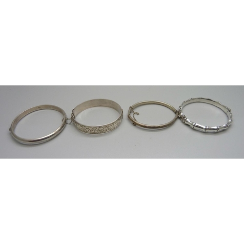 933 - Four silver bangles, 63g