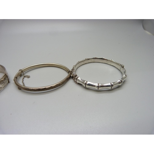 933 - Four silver bangles, 63g