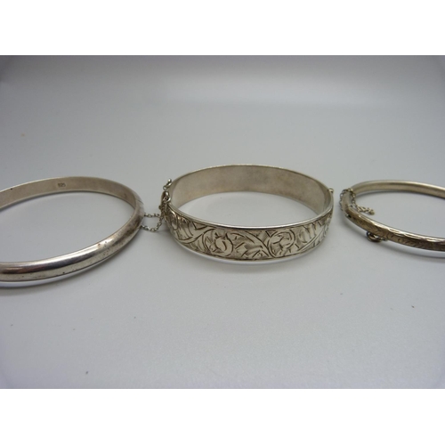 933 - Four silver bangles, 63g