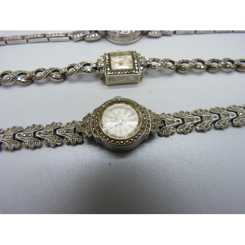 943 - Three lady's silver and marcasite wristwatches, one unmarked but tests as silver, winder missing on ... 