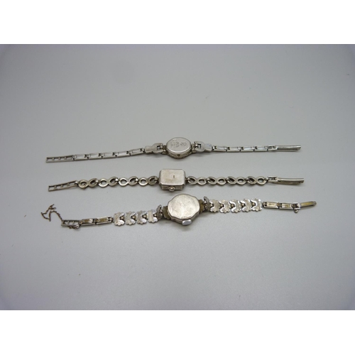 943 - Three lady's silver and marcasite wristwatches, one unmarked but tests as silver, winder missing on ... 