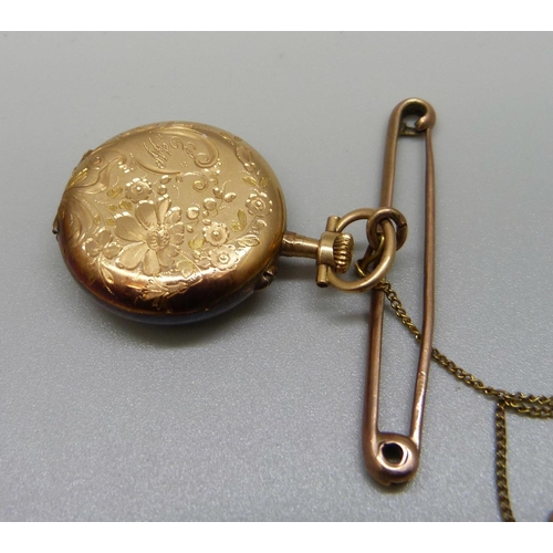 982 - A yellow metal pendant watch on a 9ct gold bar brooch, gross weight 21g