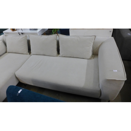 1308 - An ivory velvet corner sofa on steel legs