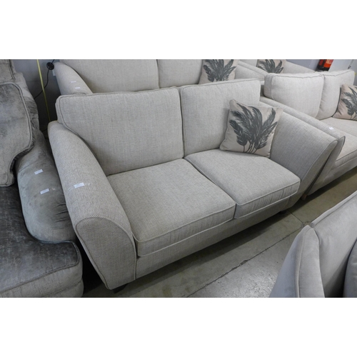 1347 - A beige textured weave two seater sofa - RRP £1099