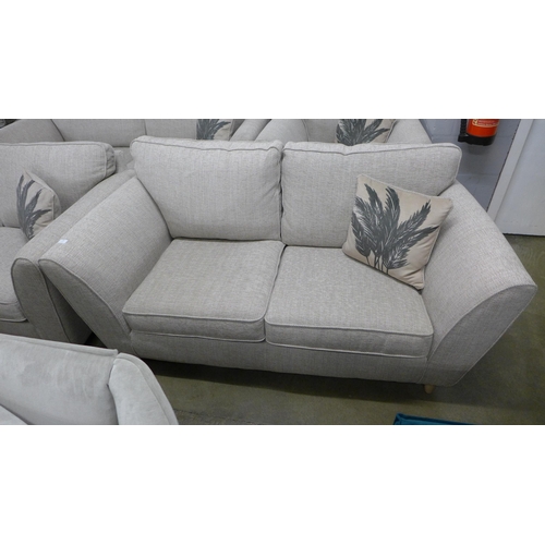 1348 - An oatmeal upholstered two seater sofa