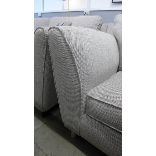 1348 - An oatmeal upholstered two seater sofa