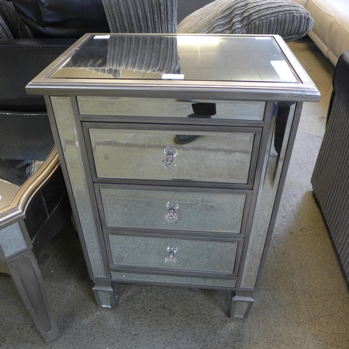 1548 - A silver mirrored three drawer chest