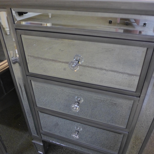 1548 - A silver mirrored three drawer chest