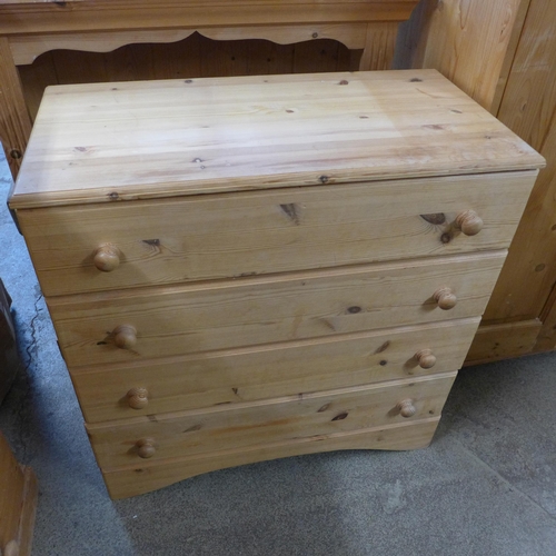 1590 - A pine floor standing gentleman's wardrobe, a chest of four drawers and a slim low bookcase