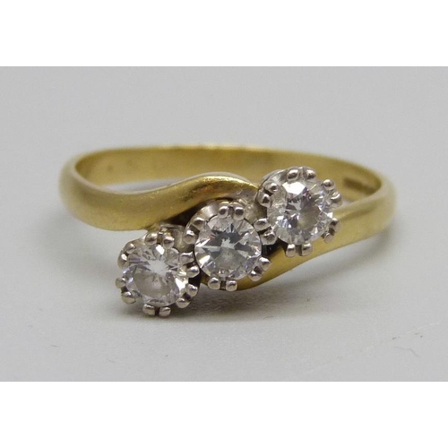 964 - An 18ct gold three stone diamond ring, 3.8g, R, 0.5ct diamond weight marked on the shank