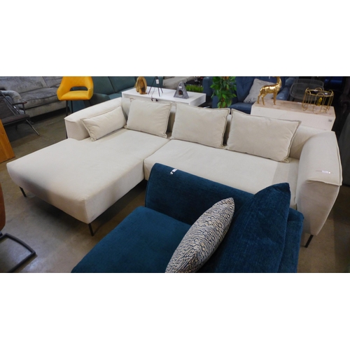 1355 - An ivory velvet corner sofa on steel legs