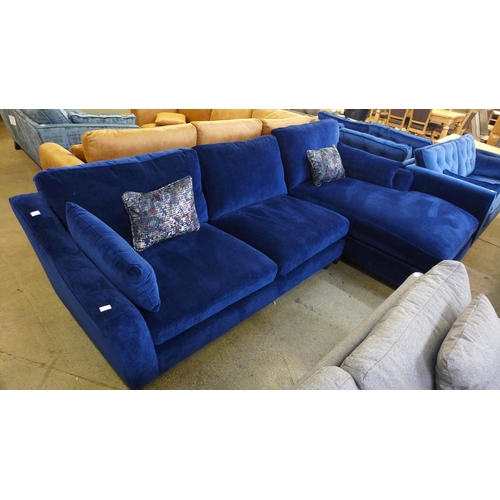 1461 - A blue velvet L shaped sofa with contrasting scatter cushions