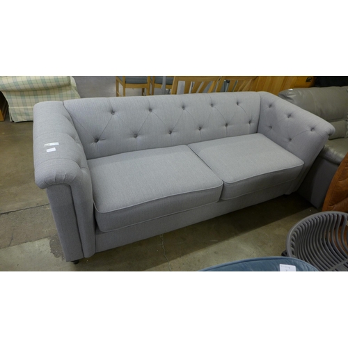 1401 - A grey upholstered buttoned three seater sofa