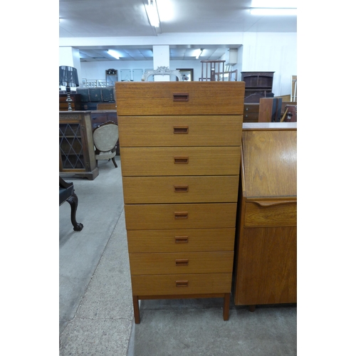 75 - A tall teak chest of drawers