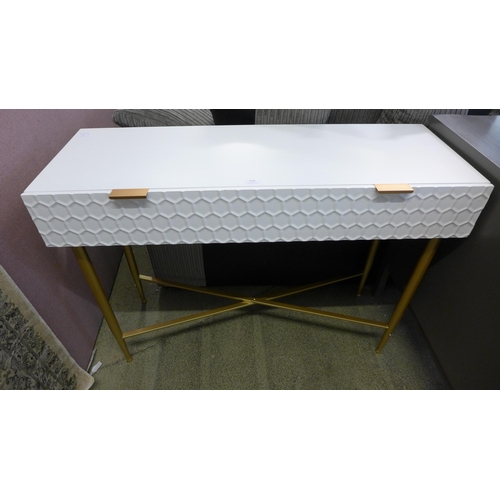 1560 - A white console table with gold legs