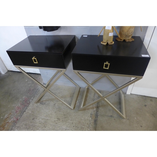 1409 - A pair of black bedside chests with cross legs - slight damage