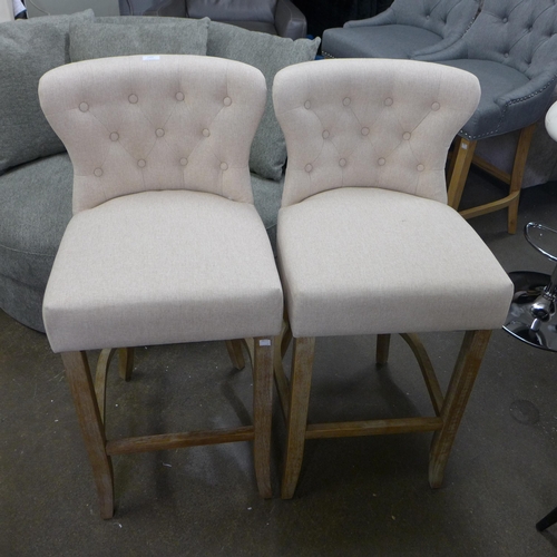 1496 - A pair of Bradley cream upholstered button back bar stools