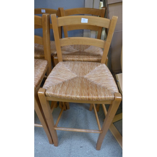 1614 - A set of four wicker and oak bar stools