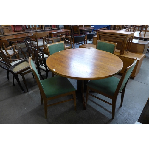 100 - A Danish teak circular dining table and four chairs