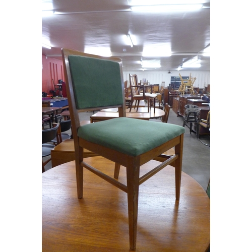 100 - A Danish teak circular dining table and four chairs