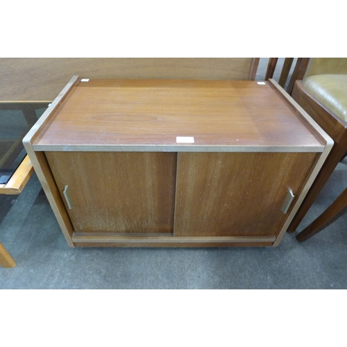 110 - A small teak two door record cabinet