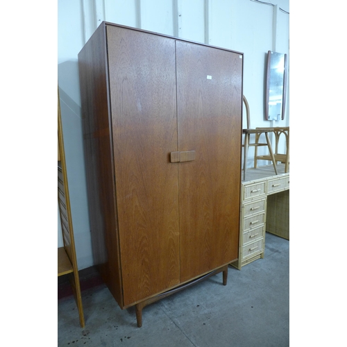 128 - A G-Plan Danish Design teak two door wardrobe, designed  by Ib Kofod Larsen