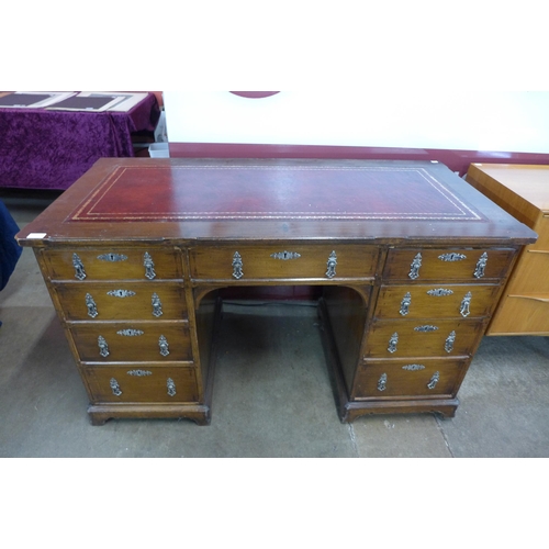 138 - A Victorian Gothic Revival oak and red leather topped desk, manner of A.W.N. Pugin