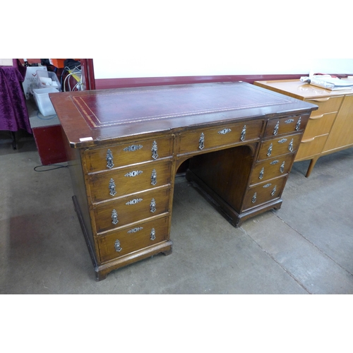 138 - A Victorian Gothic Revival oak and red leather topped desk, manner of A.W.N. Pugin