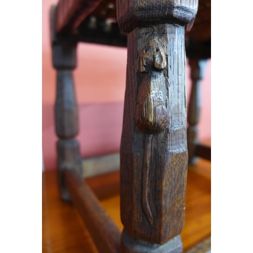 146 - A Robert Mouseman Thompson carved oak and brown leather stool