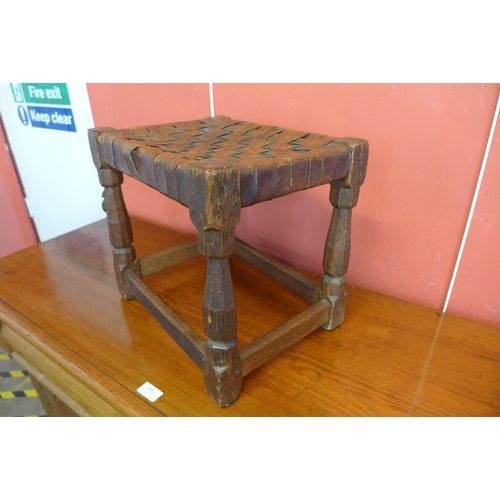 146 - A Robert Mouseman Thompson carved oak and brown leather stool