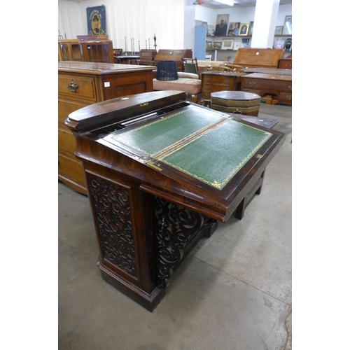 165 - An early Victorian rosewood fretwork Davenport desk, manufactured by J. Manuel, Sheffield