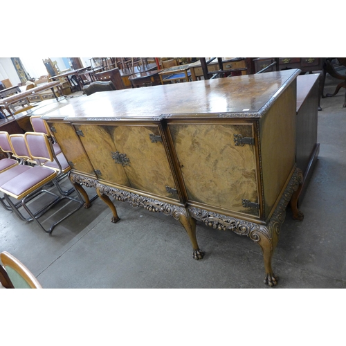 170 - An early 20th Century Queen Anne style carved burr walnut breakfront sideboard, retailed by Harrods,... 