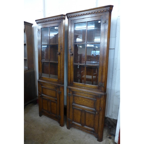 183 - A pair of Titchmarsh & Goodwin oak freestanding corner cabinets