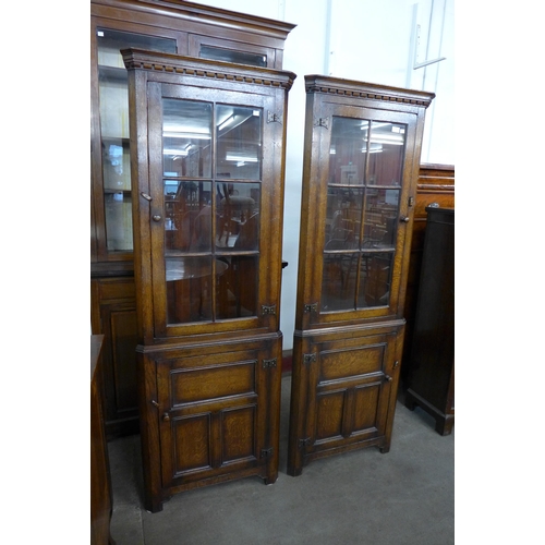 183 - A pair of Titchmarsh & Goodwin oak freestanding corner cabinets