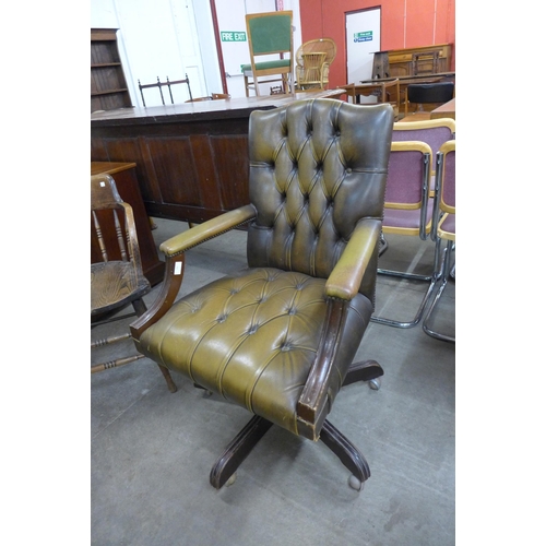 191 - A mahogany and brown leather revolving desk chair, a/f