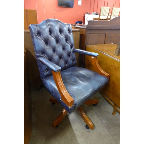 196 - A Gainsborough style beech and blue leather revolving desk chair