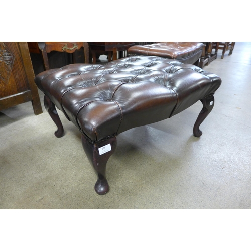 205 - A mahogany and chestnut brown leather Chesterfield footstool