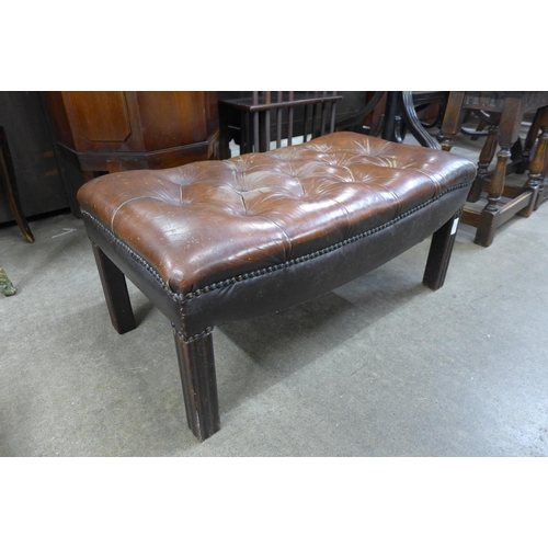 206 - A mahogany and brown leather buttoned footstool