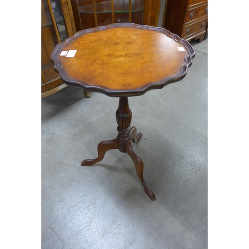 217 - A burr walnut tripod wine table