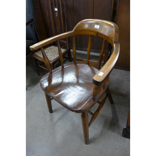 219 - An elm and beech smokers bow armchair