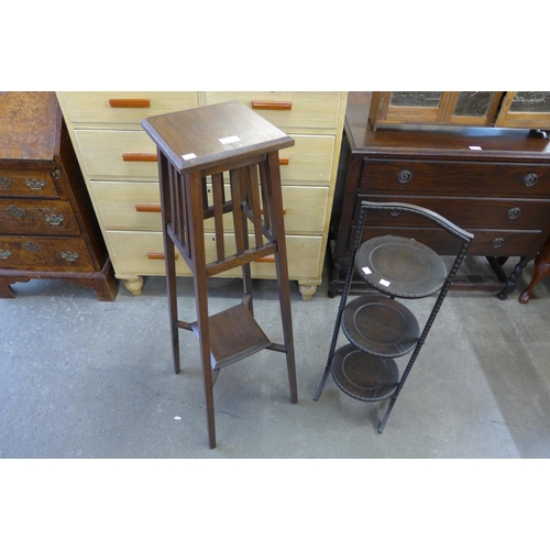 222 - An Arts and Crafts oak jardiniere stand and an oak folding three tier cake stand